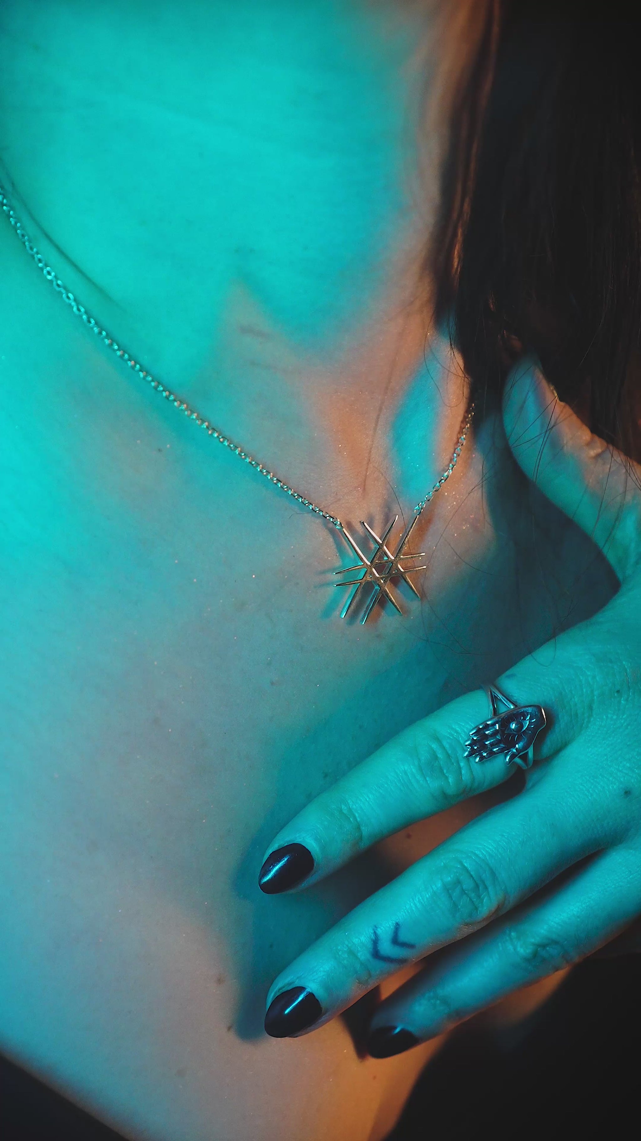 Silver geometric pendant on a model